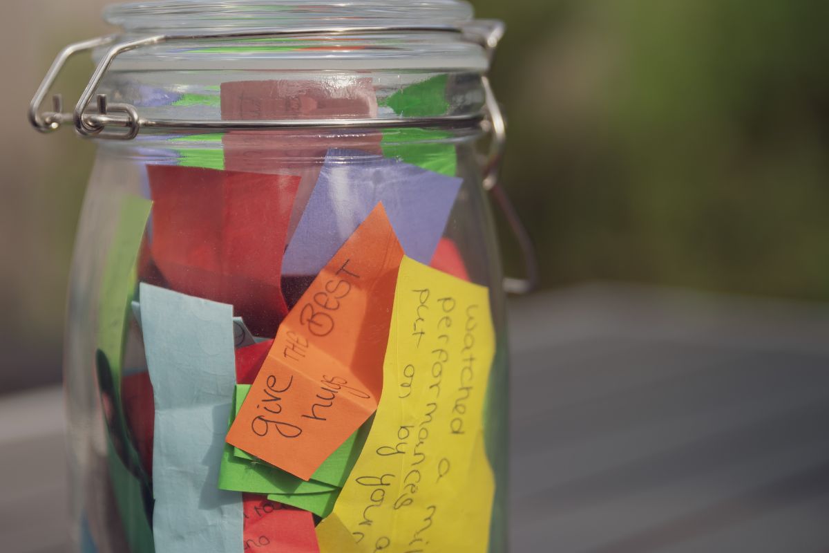The photo shows a jar filled with notes on the paper which means to keep a success jar helps you see progress, reminds you how far you've come, and builds confidence to keep going. 