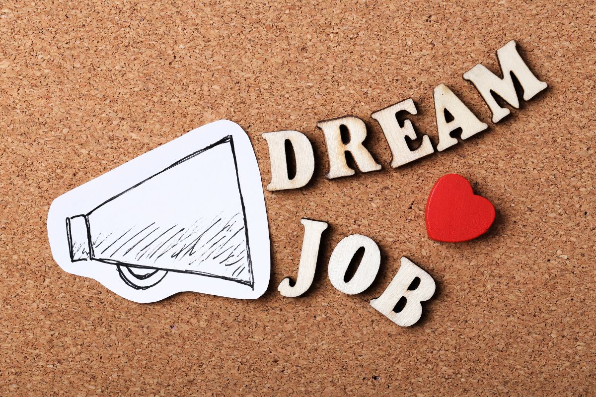 The image tells about a paper with a drawing and notes with a heart shape which means getting clear on what your dream job looks like and taking the right steps to make it happen.