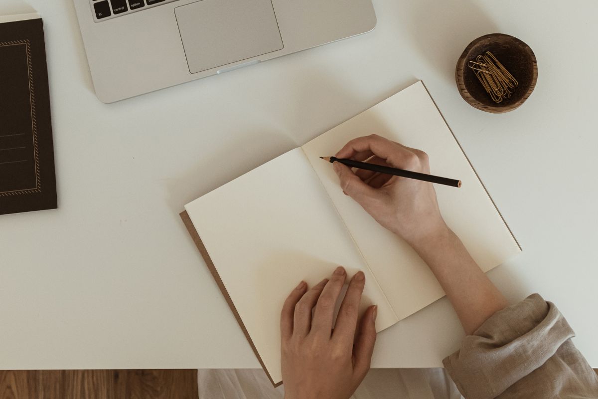 Image of a woman's hand writing a dream job.