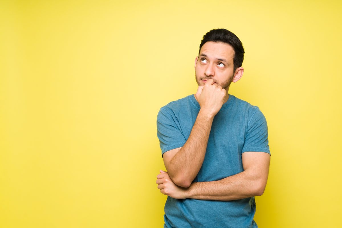 The photo shows a man thinking deeply referring to visualize yourself in the role helps boost confidence and prepare for interviews.