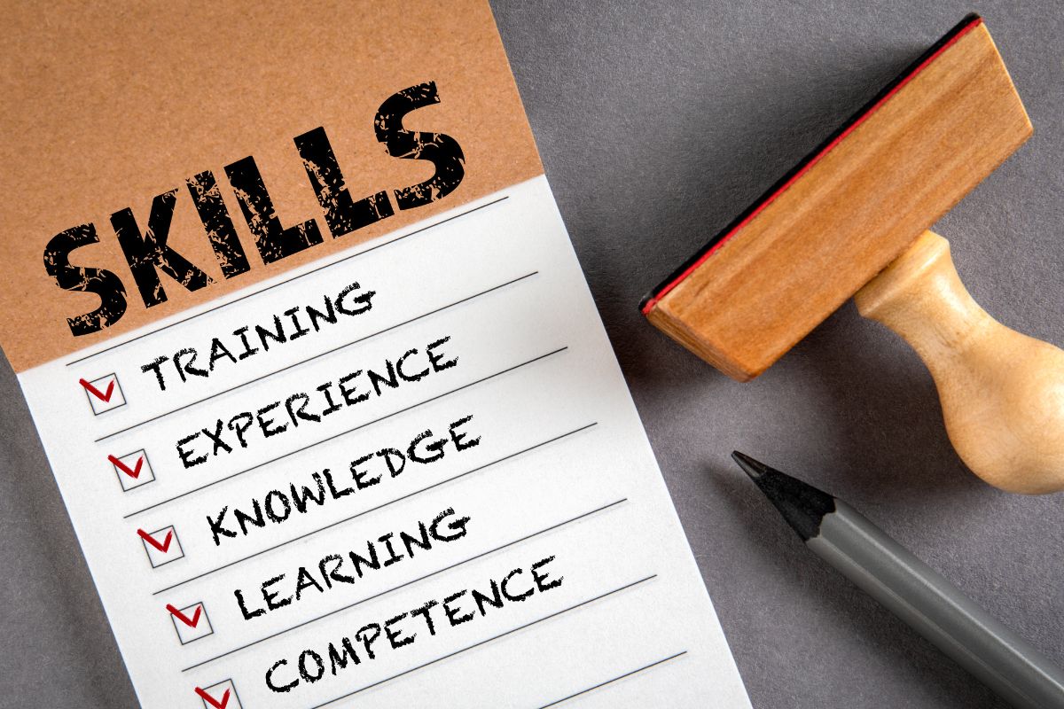 The image shows a stamp and notebook with skills.
