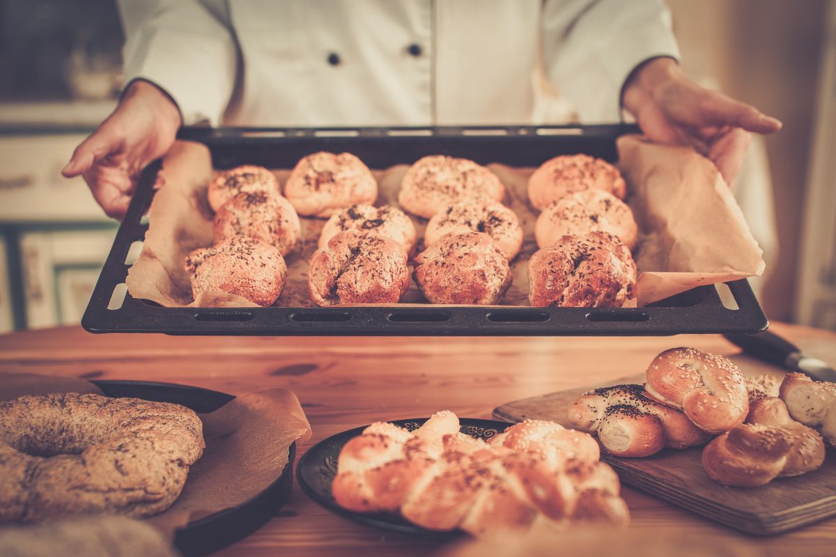 The picture of bread on the plates and a girl's hand holding a plate of baked bread indicating to offer a flash sale on something you make is an easy way to turn your skills into cash fast.