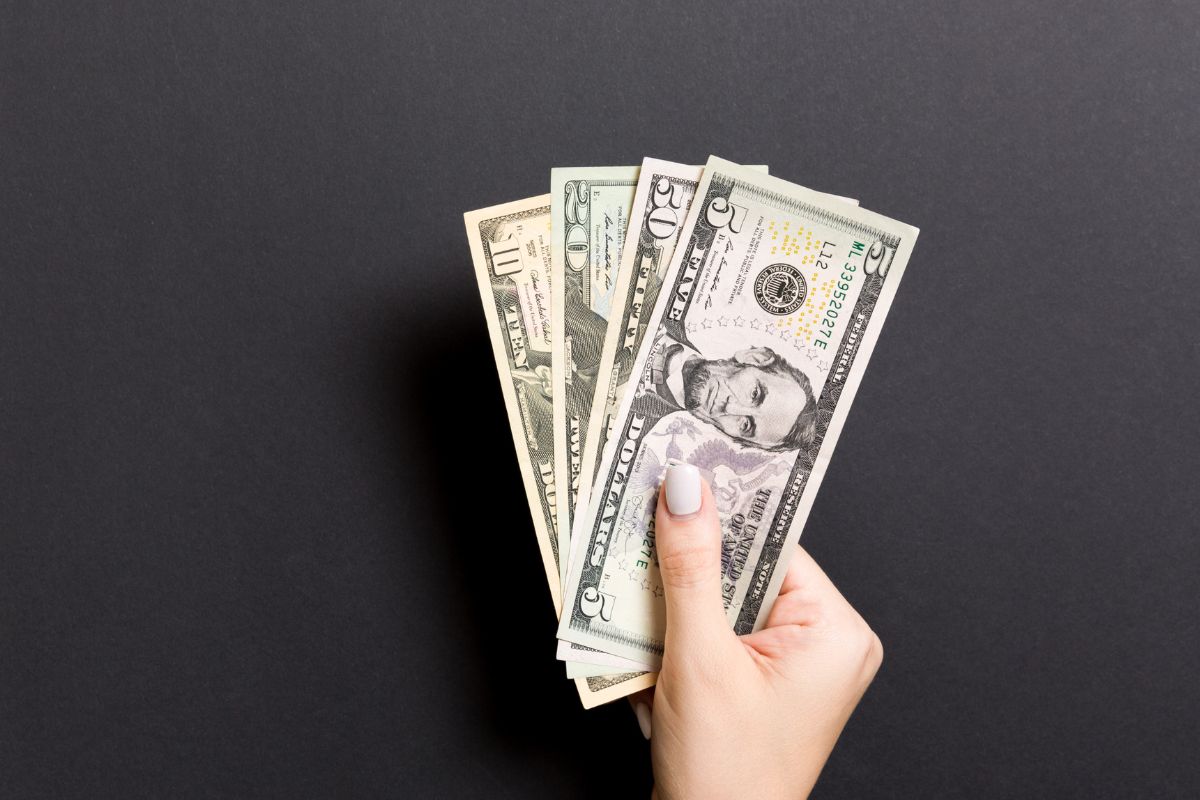 Picture of woman's hand holding money.
