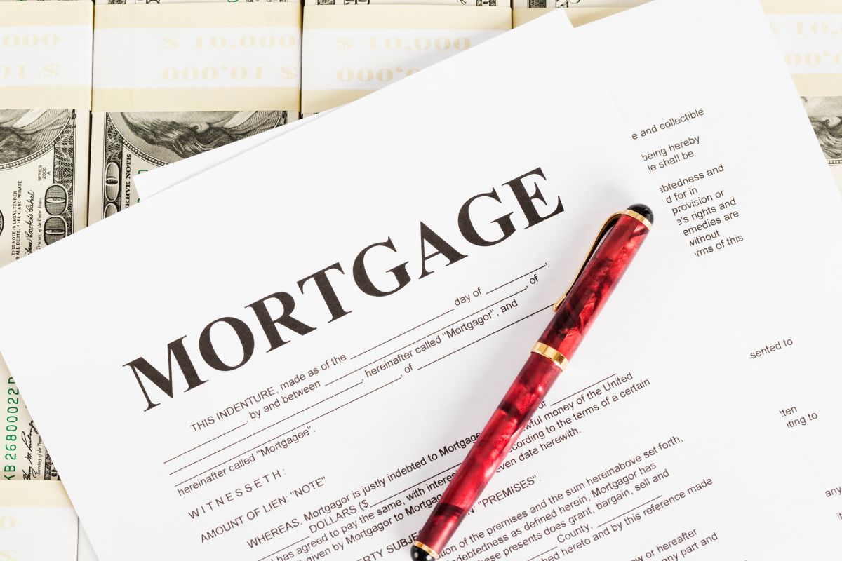 The picture shows a pen and mortgage paper.