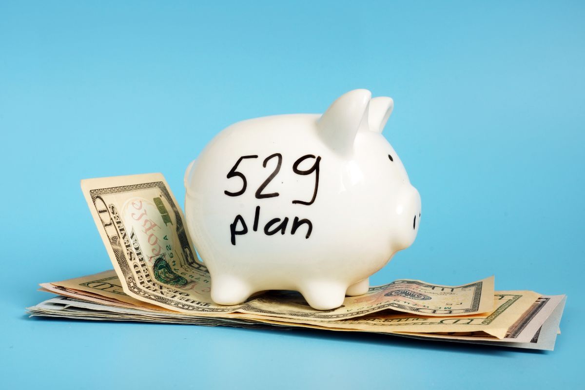 The picture tells about dollar bills and a piggy bank with notes indicating to contribute to a 529 plan for education savings making it a smart way to plan for future education costs while reducing tax liability.