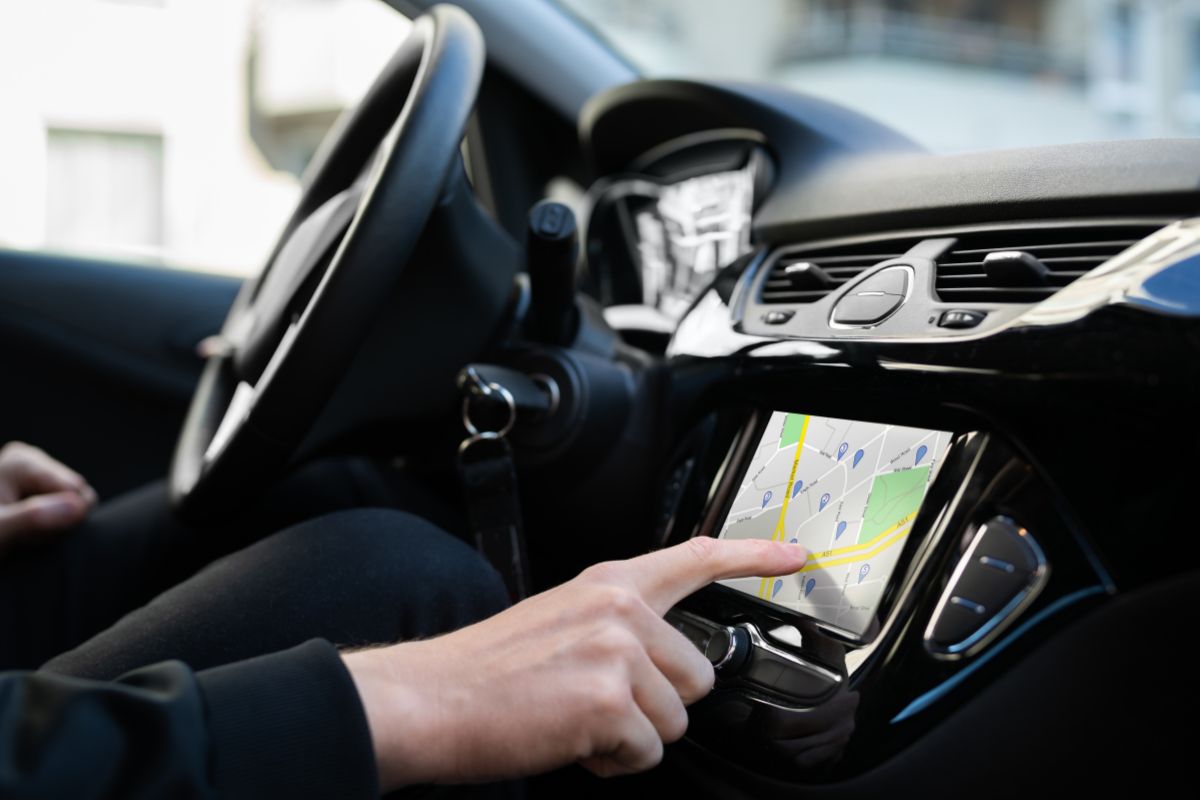 Photo of a woman driving a car for business.