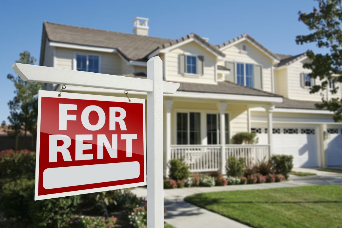 The picture tells about a house with red signage referring to taking advantage of rental property deductions makes real estate investing more profitable.