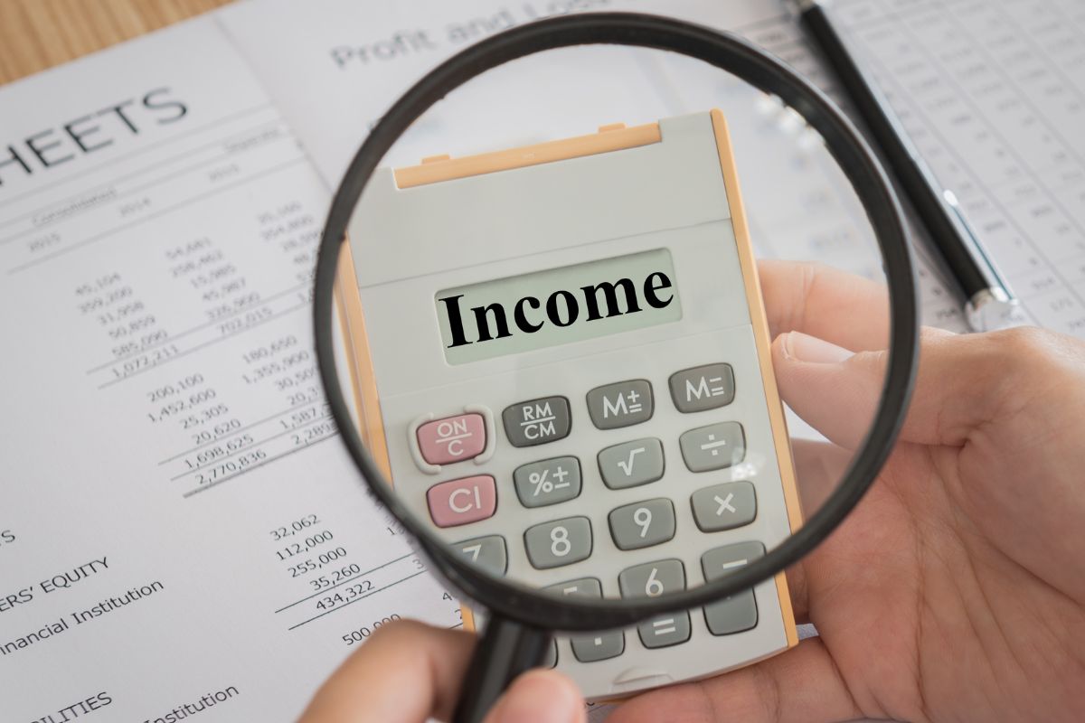 The photo shows a man calculating his income.