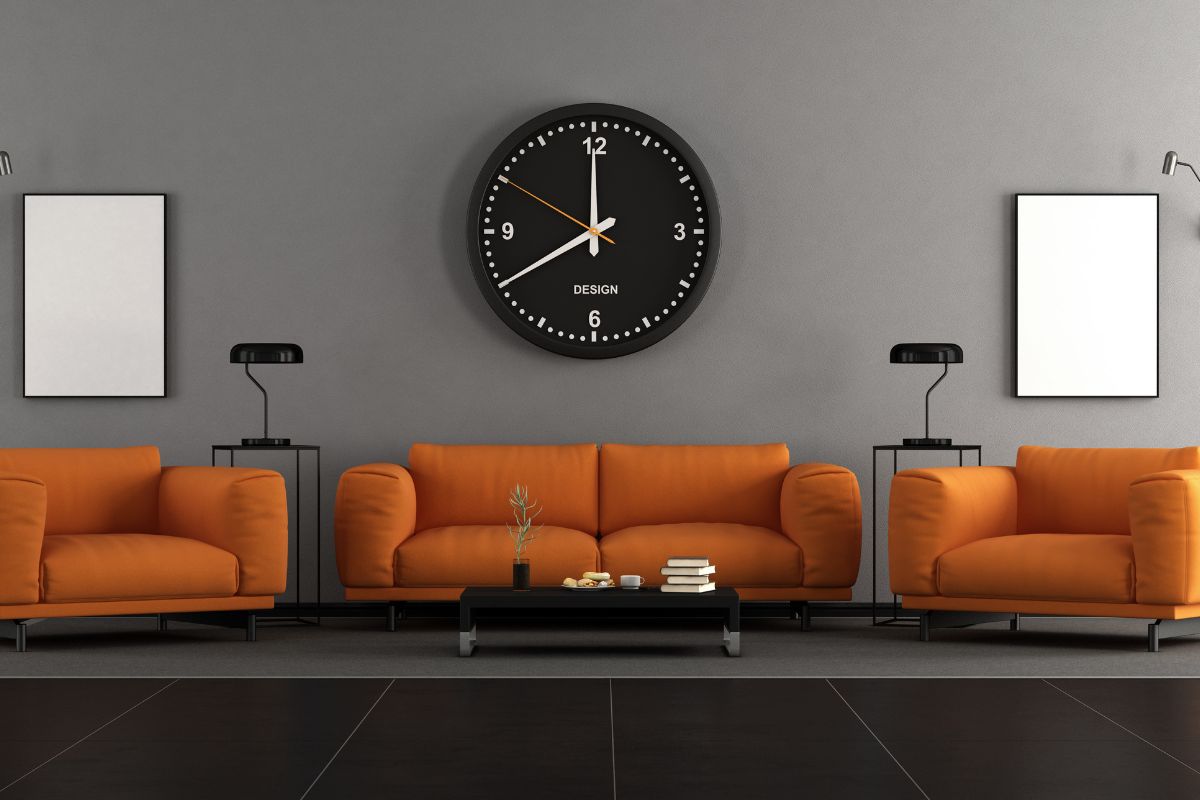 The picture tells about sofas, a clock, a table with books, and a plant indicating that paying in cash for furniture keeps you from spending more than planned and avoiding long-term debt.