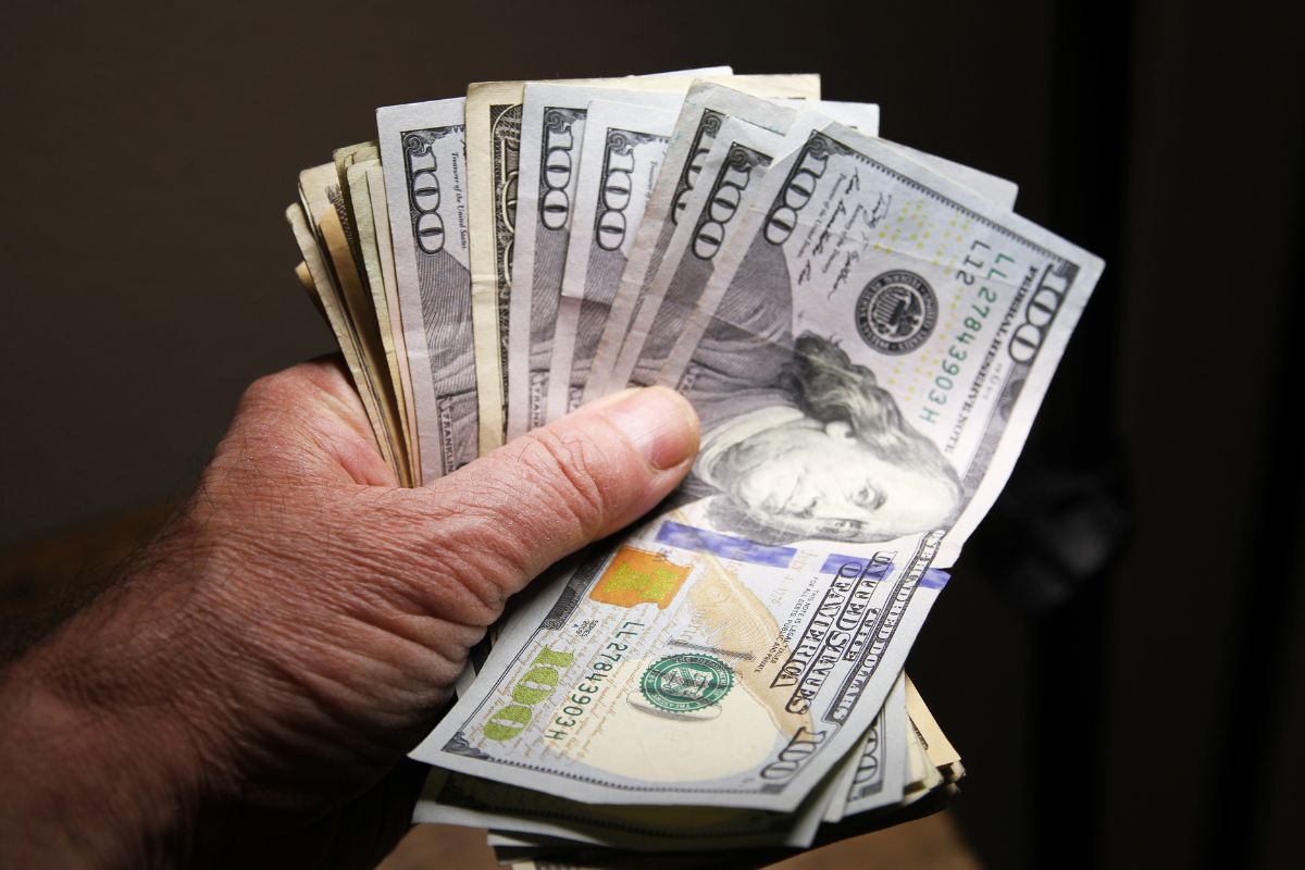 Image of a man's hand holding money.