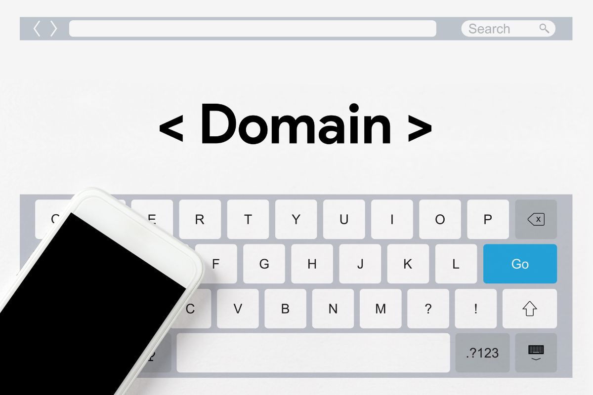 The image shows a phone and a screen display with a note and keyboard which means to flip domain names for profit can be a good way to earn money from home.