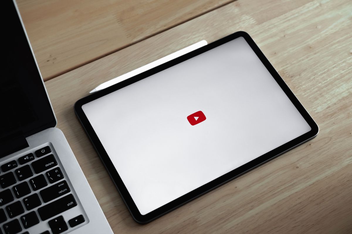 The photo shows a laptop with a tablet device with a logo indicating that starting a YouTube channel and monetizing with ads is also great for making money in your spare time.