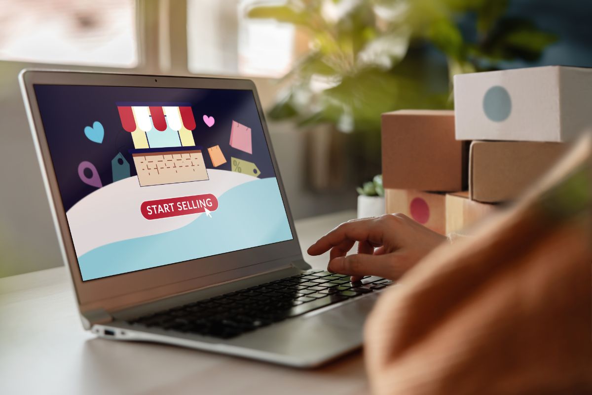 The image tells about boxes and a girl's hand using a laptop with a screen display indicating that buying bulk items from liquidation sales and reselling online is a reliable way to make extra cash from home.