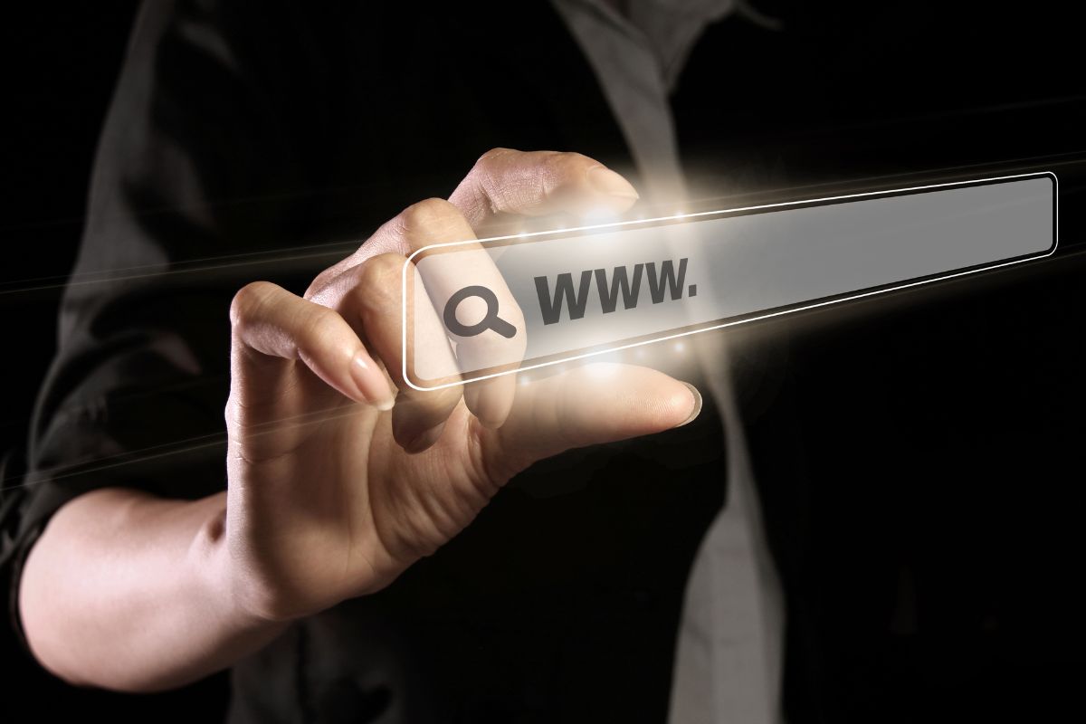 An image of a man's hand flipping websites.