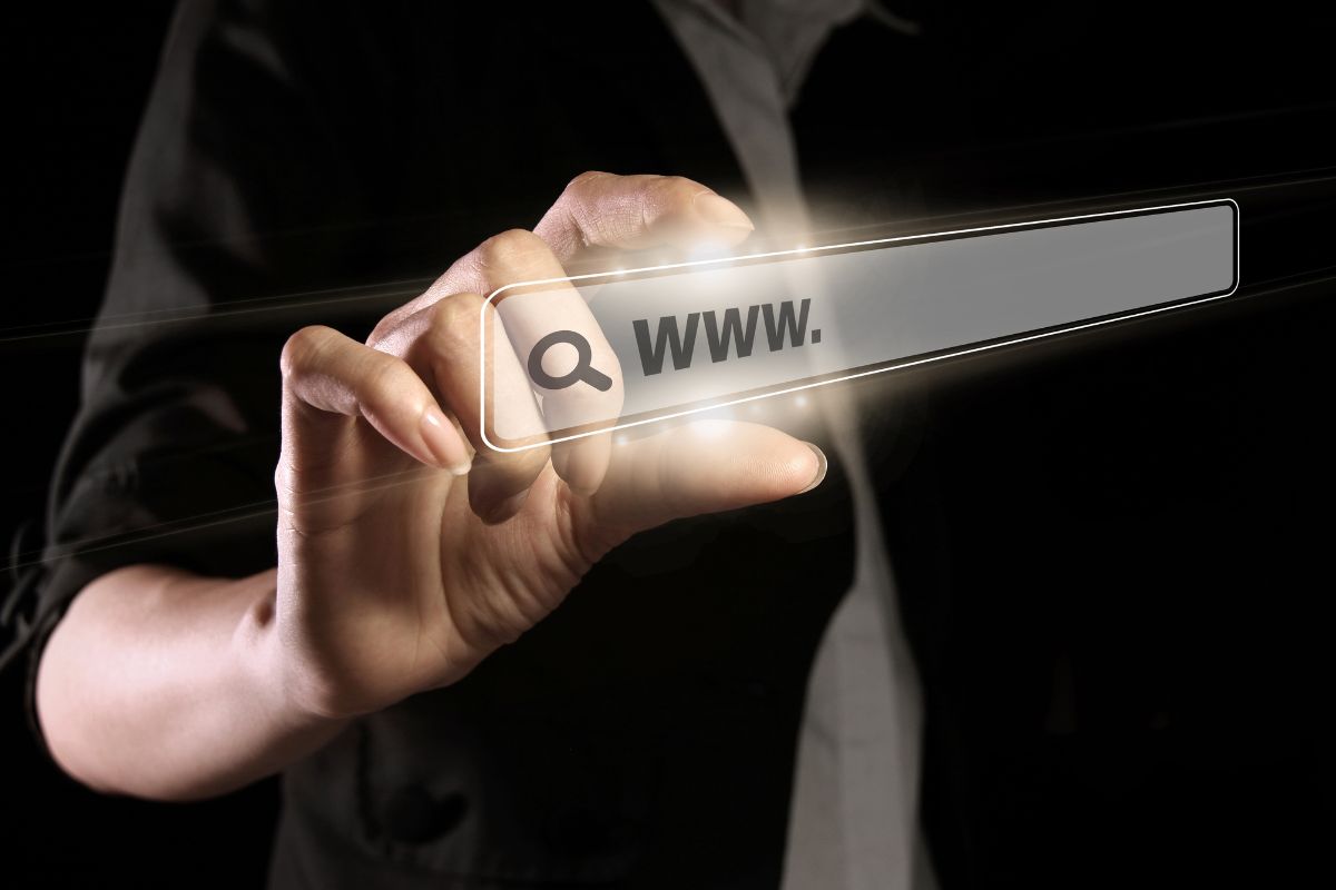 The photo tells about a man's hand holding a visual search referring to building and flipping websites for profit can be a smart way to earn extra cash.
