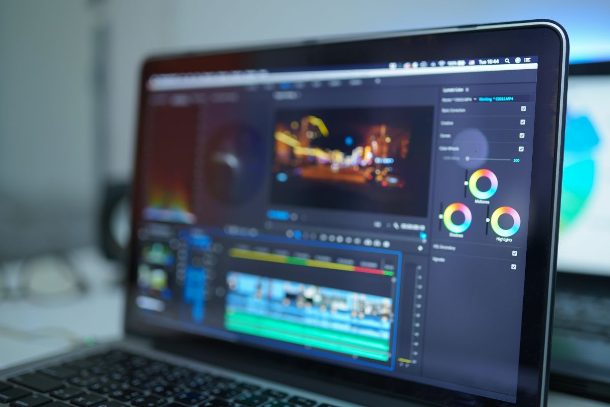 An image shows editing videos on a laptop.