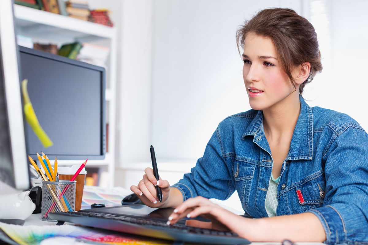 The image tells about a girl working on her computer indicating to create and sell AI-generated art can earn money every time someone makes a purchase.