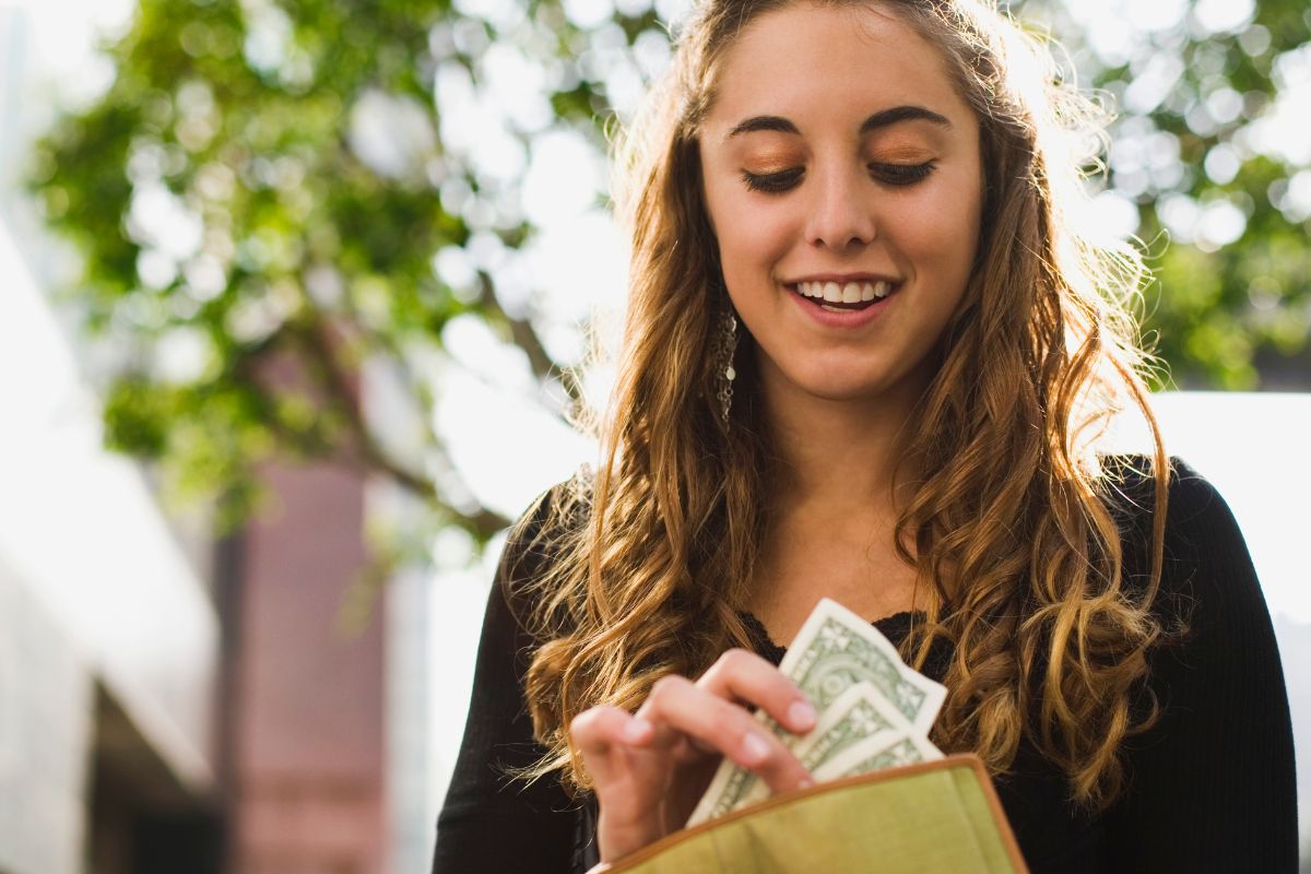 The picture shows a woman keeping her money.