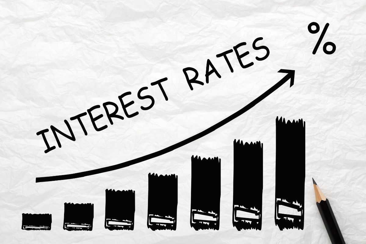 The photo shows a graph with an arrow, percentage, and notes which means that refinance high-interest debt can lower your rate and reduce your payments.