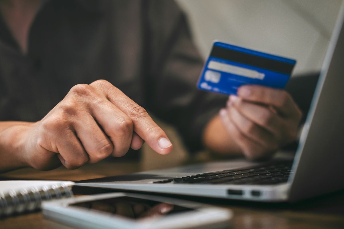 Picture of a woman's hand automating credit card payments.