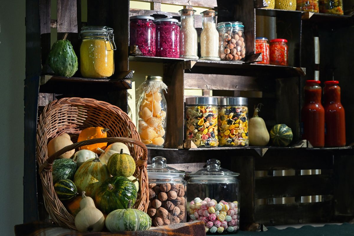 The photo shows vegetables on a basket and other ingredients in the corner referring to trying a pantry challenge is a fun way to use up forgotten ingredients while cutting down on grocery bills.