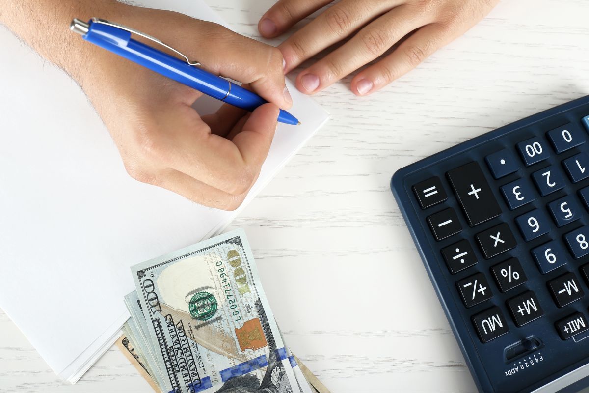 Photo of a man's hand tracking his money. 
