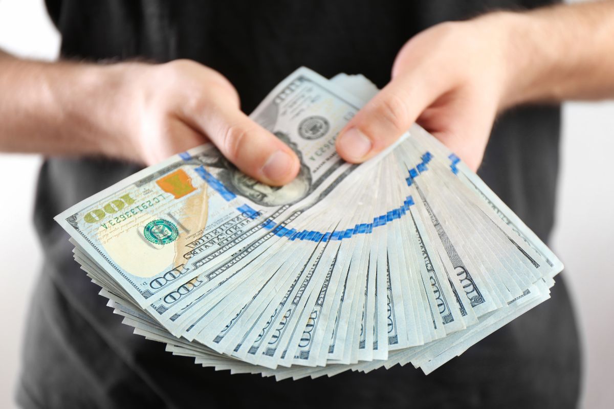 An image of a woman holding money.