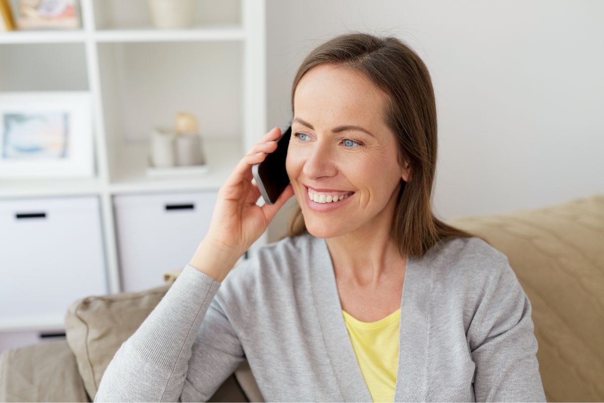 Photo of a woman talking on the phone for negotiating.
