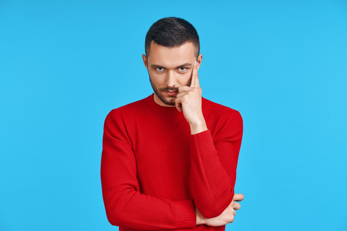 The image shows a man thinking indicating to think decades ahead to make it easier to reach financial goals.