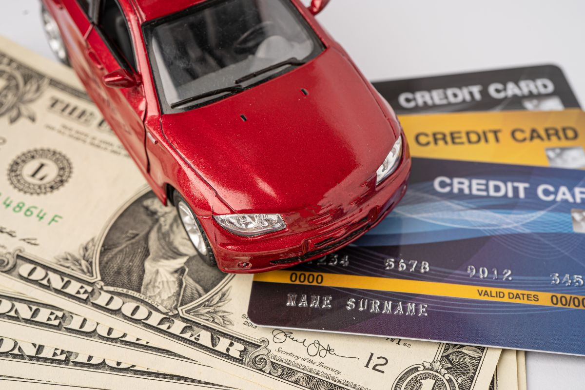 Picture of money, credit cards, and a car.