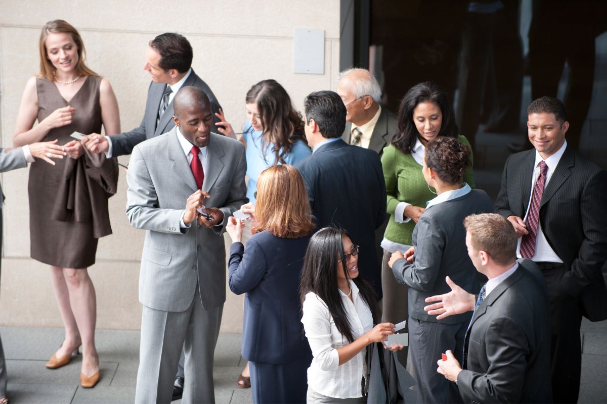 An image shows a group of people networking.