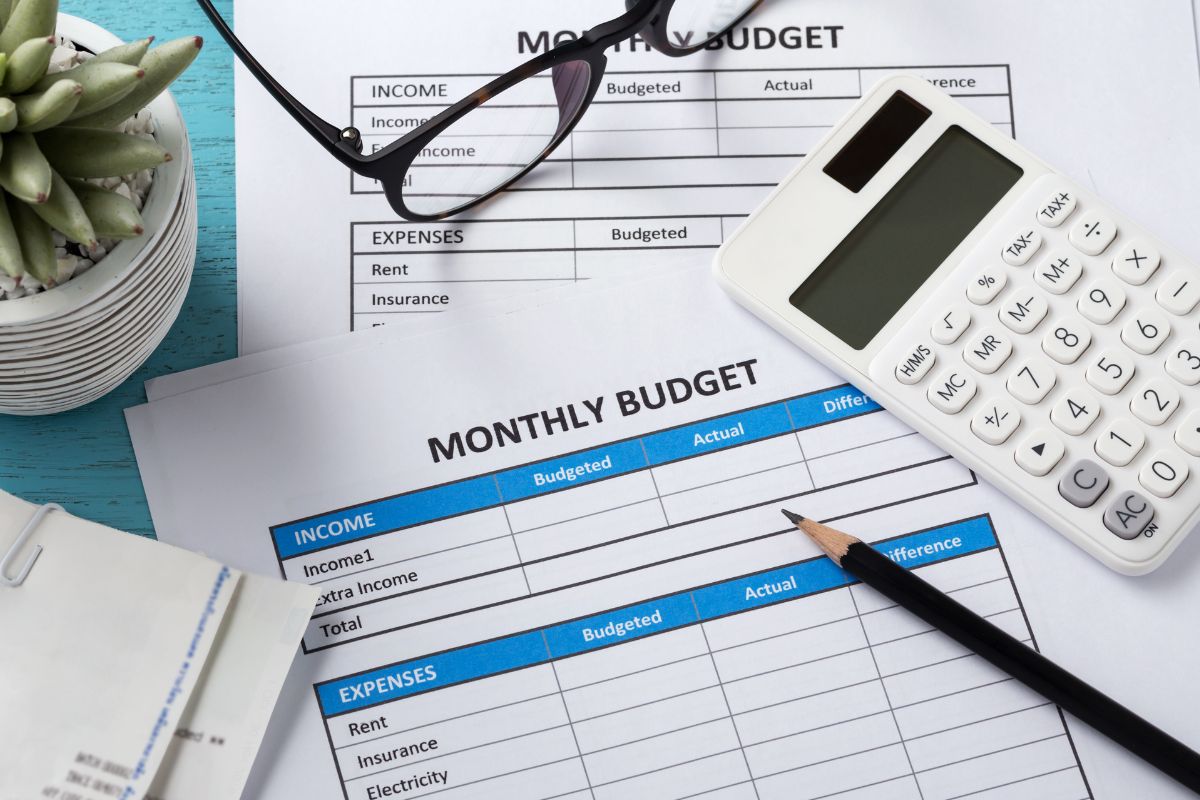 Image of a calculator and monthly budget forms.