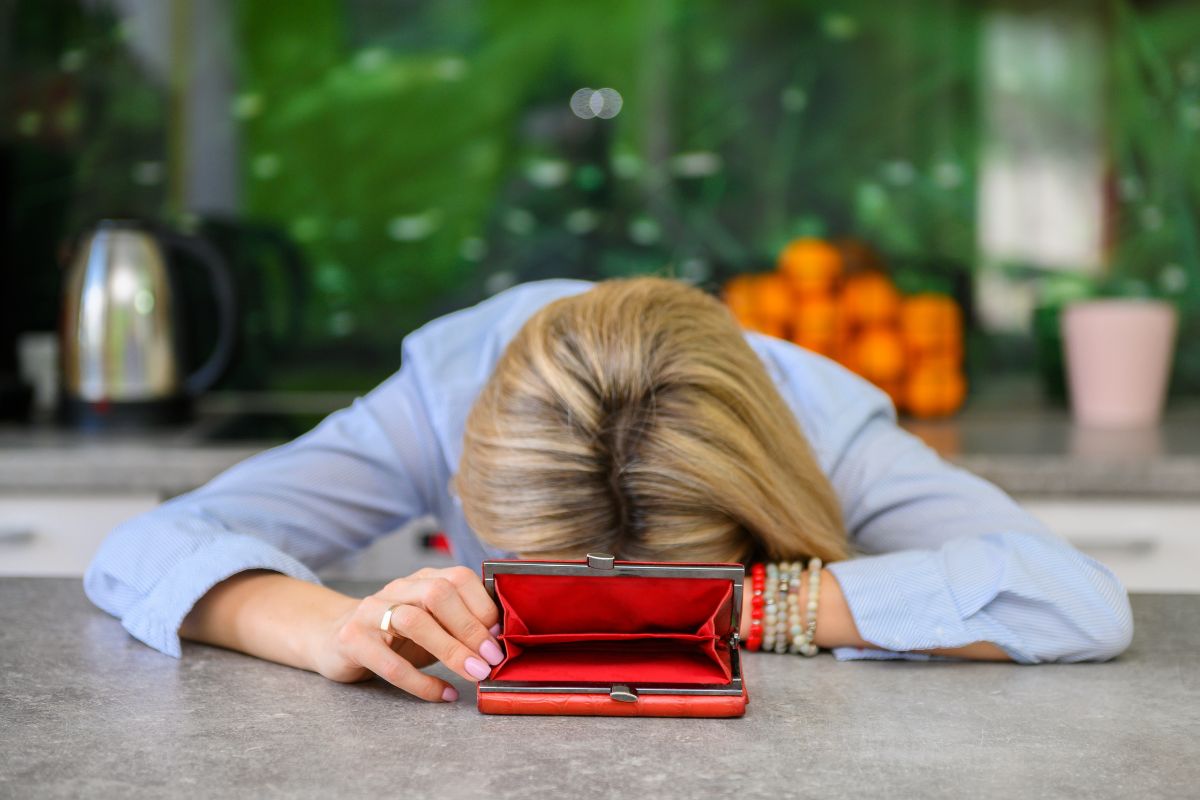 An image of a woman with an empty wallet.