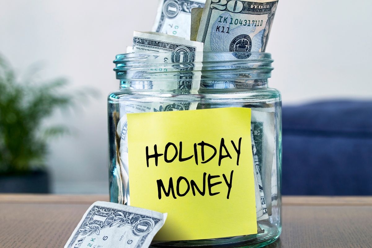 The picture shows a jar filled with dollar bills and notes which means to plan for irregular expenses keeps from wrecking your finances and helps you avoid last-minute stress.