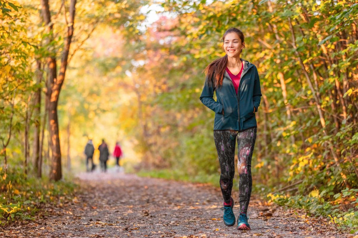 The picture shows a girl walking at the shady trees which means that planning free activities is a great way to stay entertained without spending money.