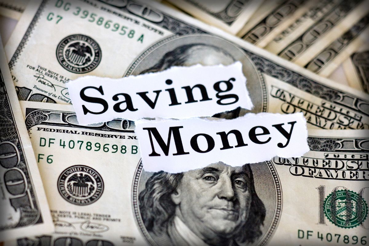 The photo shows dollar bills and papers with notes which means that finding the money-saving challenge for you becomes a habit instead of a struggle.