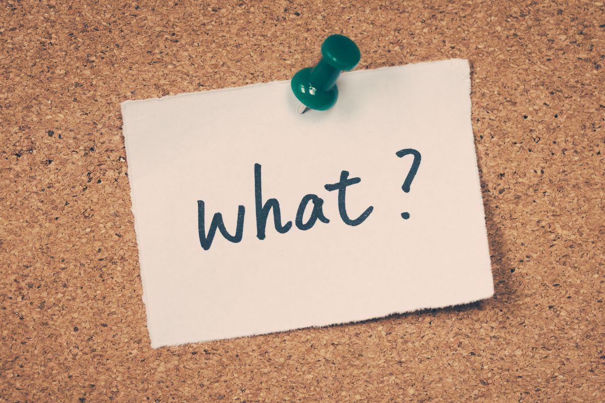 The image shows a piece of paper with a note pinned on the board which means what is the 50/30/20 rule that helps keep your spending balanced so you can cover your bills while saving for the future.