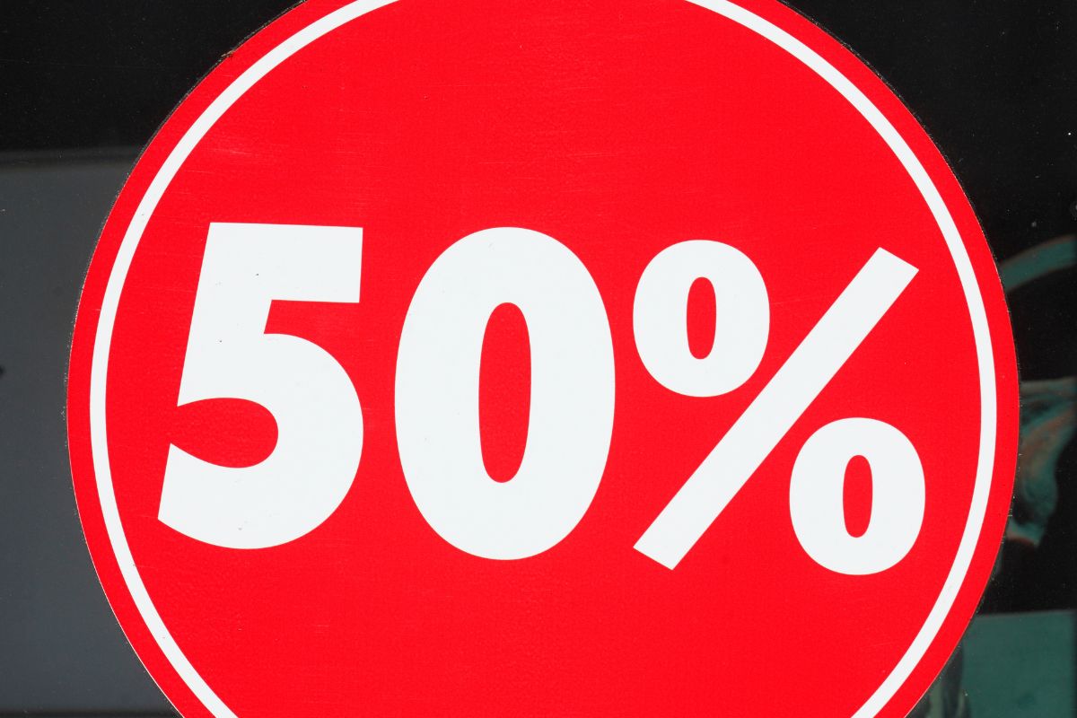 The image shows a red circle signage with a number and percentage referring to 50% needs of your costs to go over making it easier to manage your money without stress.