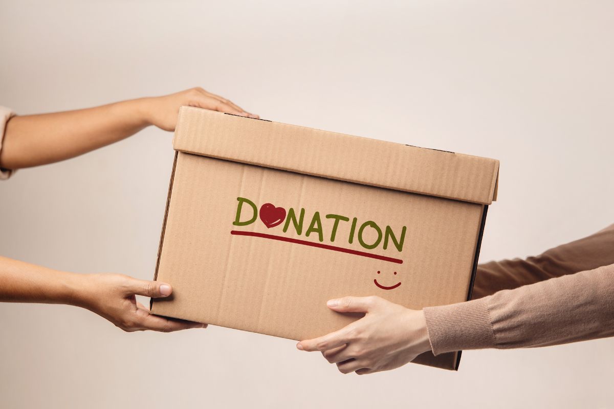 The picture tells about a girl's hand handing the box with a note to the girl's hand indicating giving and donations, planning ahead of these lets you be generous while financially responsible.