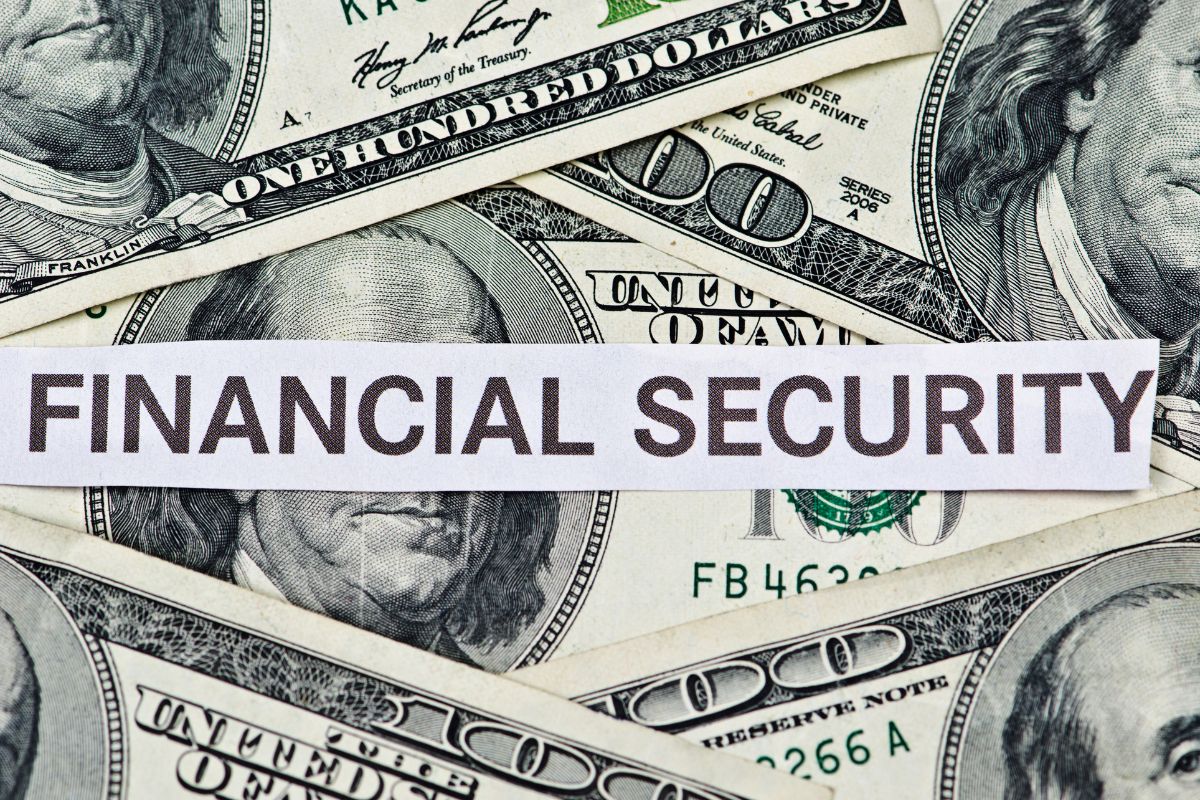 The photo shows dollar bills and a piece of paper with notes indicating that having money set aside ensures financial security that keeps you from stressing when something unexpected happens.