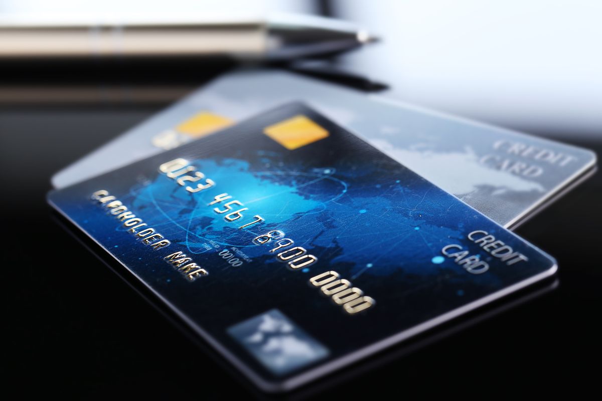 The image shows credit cards on the table referring to how freezing your credit card can help break the habit of reaching for a card without thinking.
