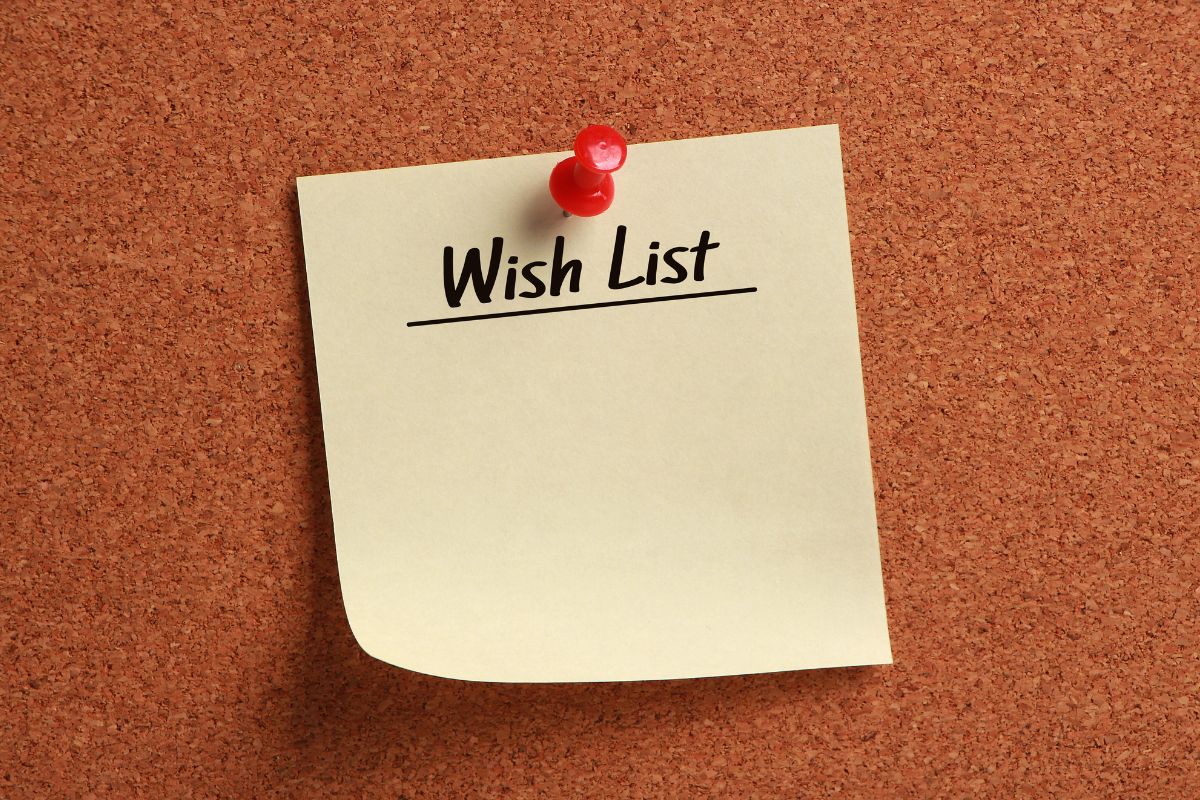 The photo shows a piece of paper with notes pinned on the board indicating that using a wish list instead of buying immediately helps break the cycle of instant gratification spending.