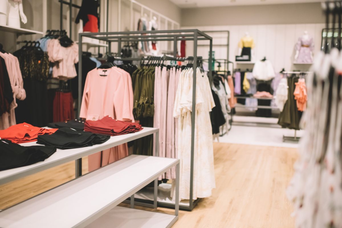 The picture tells about the clothes hung on the rack and on the tables which means to avoid stores completely keeps the focus on saving money and following the rules of the challenge.