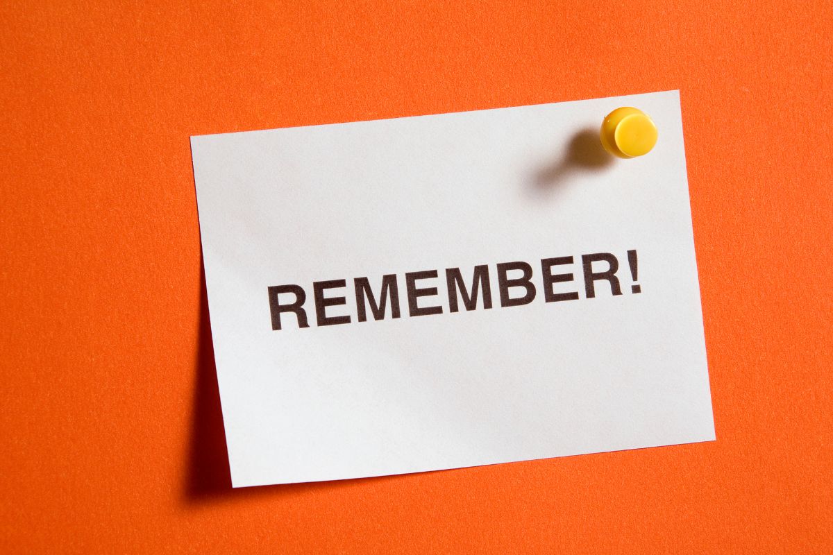 The photo tells about a piece of paper with a note pinned on the wall referring to remembering that every dollar saved is a step to financial security making it easier to skip impulse buys.