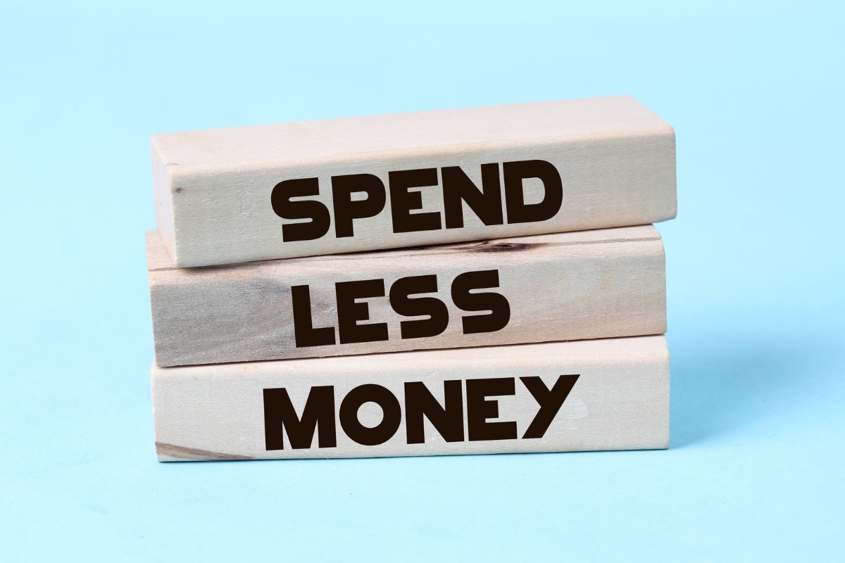 The photo shows rectangular woods with notes indicating that living below your means is the key to long-term financial security.