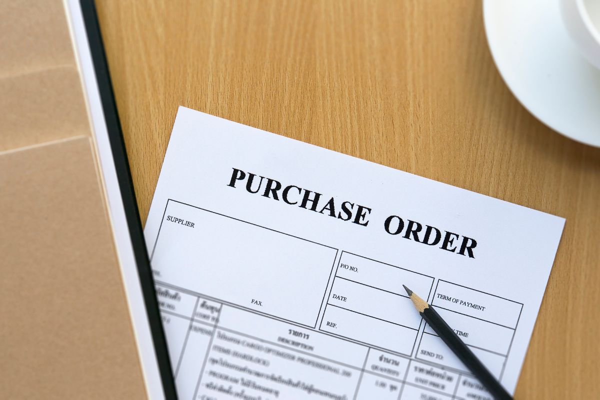 The image tells about a coffee, a pen, and a piece of paper with notes which means delaying big purchases with a 30-day rule keeps money in your pocket and helps you focus on savings.
