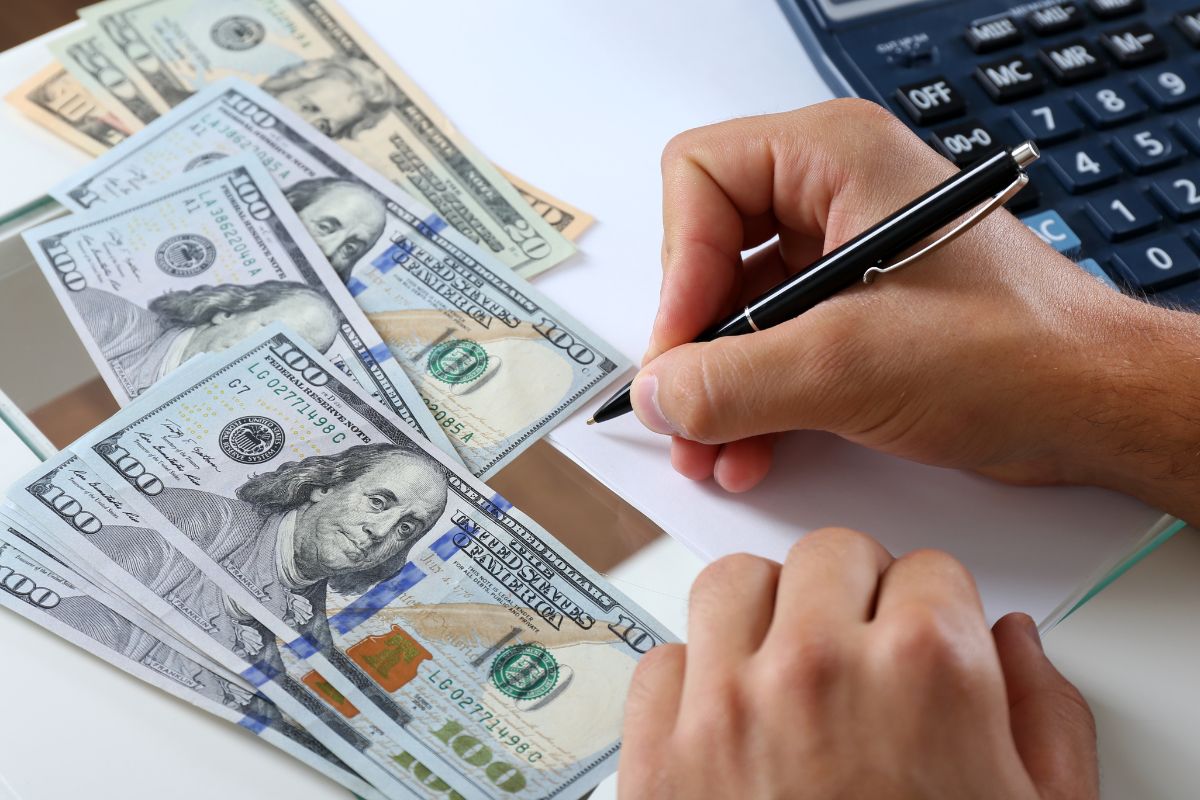 The photo shows a man's hand setting a spending limit.