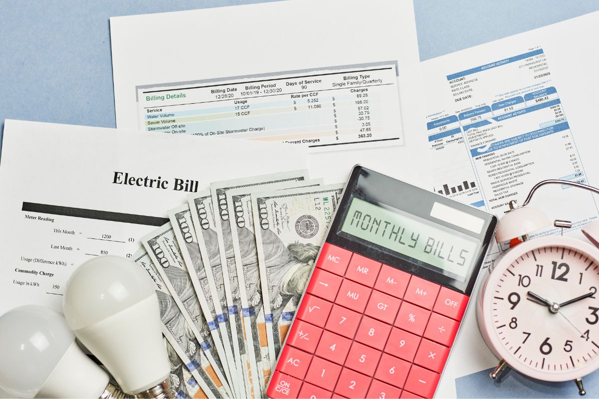The picture shows money and monthly bills invoices.