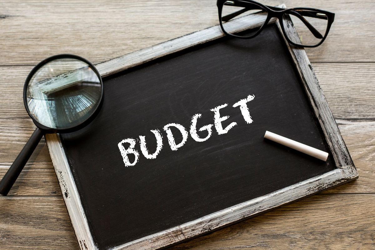The photo shows a board with budget wording.