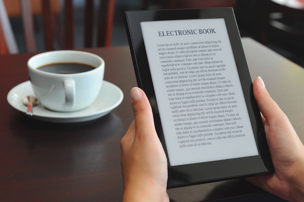The image shows a woman reading an E-book.
